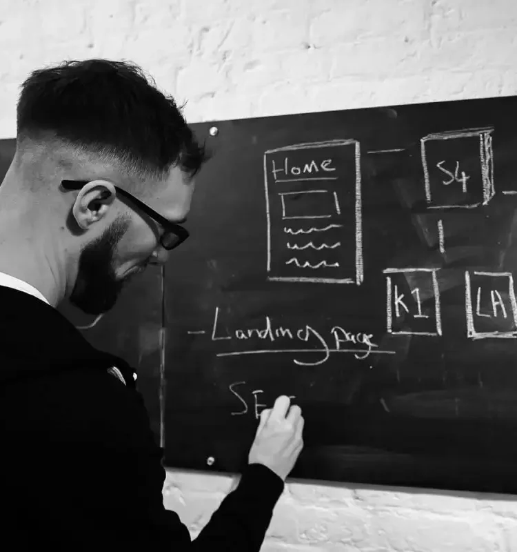 B2B marketing agency expert developing a new project idea on a chalkboard